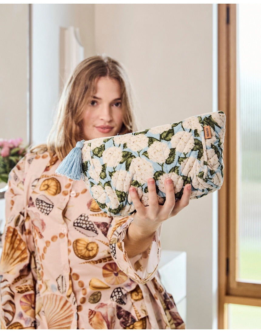 Kip&Co velvet toiletry bag in Hydrangea Blue with floral pattern, soft fabric, and zip closure for travel organization
