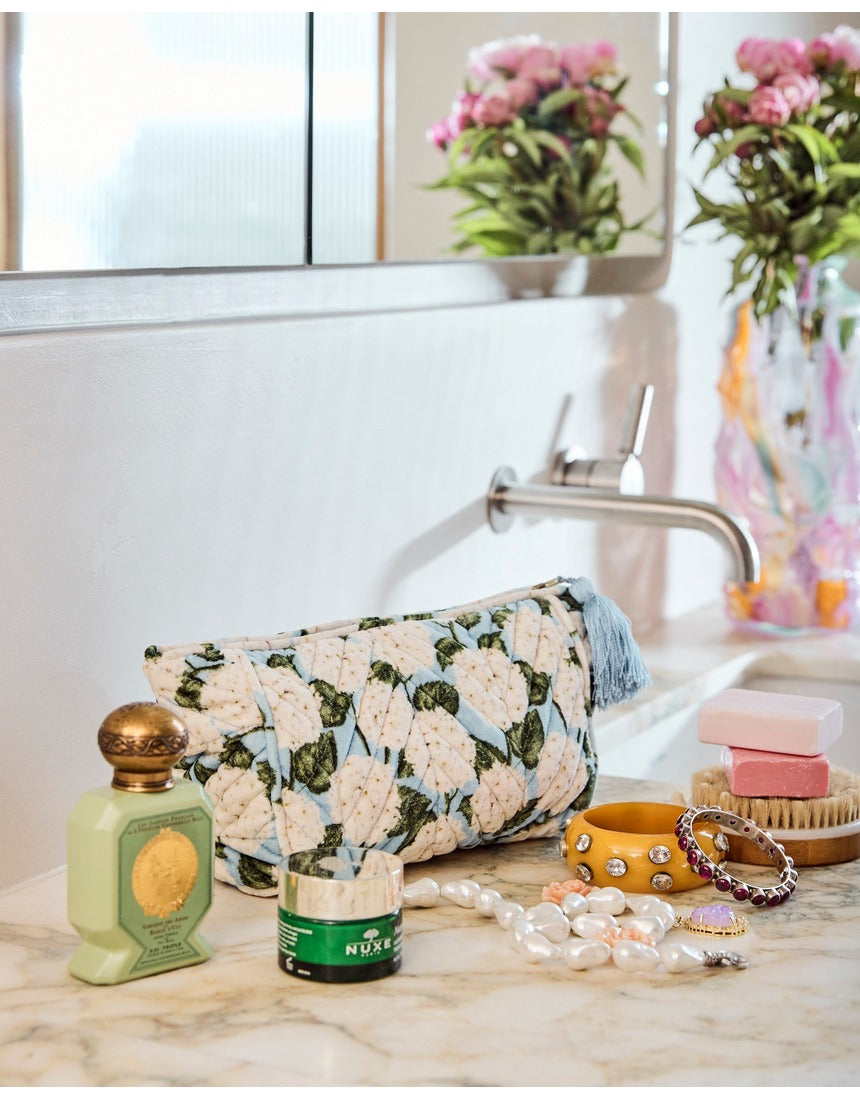 Kip&Co velvet toiletry bag in Hydrangea Blue with a floral pattern, soft fabric, and zip closure.