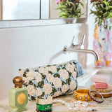 Kip&Co velvet toiletry bag in Hydrangea Blue with a floral pattern, soft fabric, and zip closure.