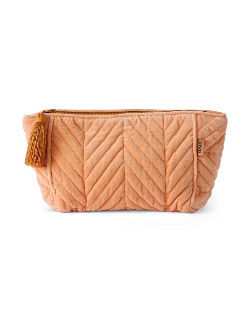 Kip&Co velvet toiletry bag in vibrant melon color, featuring a soft fabric exterior and spacious interior for travel essentials.