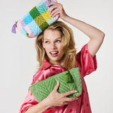 Kip&Co velvet toiletry bag in pesto color with zipper closure, soft fabric, and compact design for travel storage.