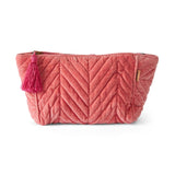 Kip&Co velvet toiletry bag in strawberry color, soft fabric with zipper closure, designed for travel toiletries storage.