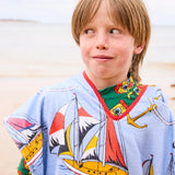 Kip&Co printed kids terry poncho with sailor-themed design, soft fabric, and hood, perfect for children’s outdoor comfort.