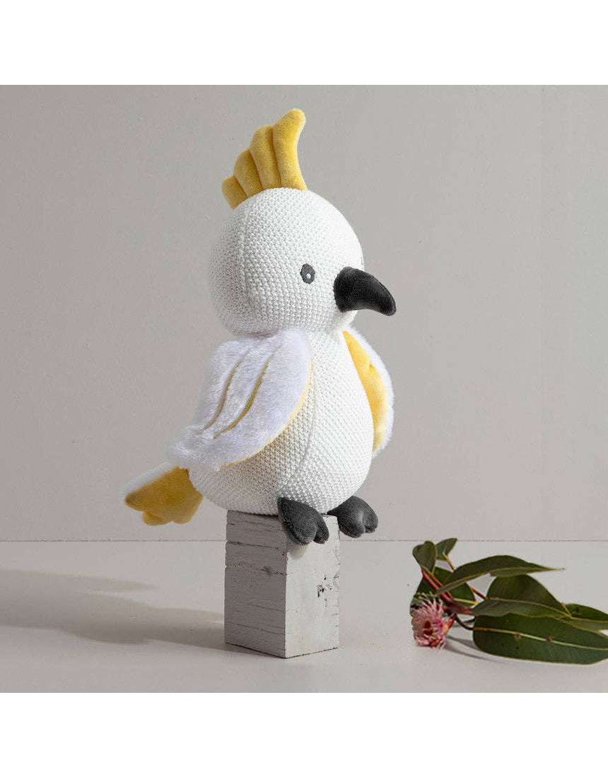 Living Textiles knitted toy Colin the Cockatoo, a soft plush bird with detailed feathers and bright colors.