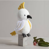 Living Textiles knitted toy Colin the Cockatoo, a soft plush bird with detailed feathers and bright colors.