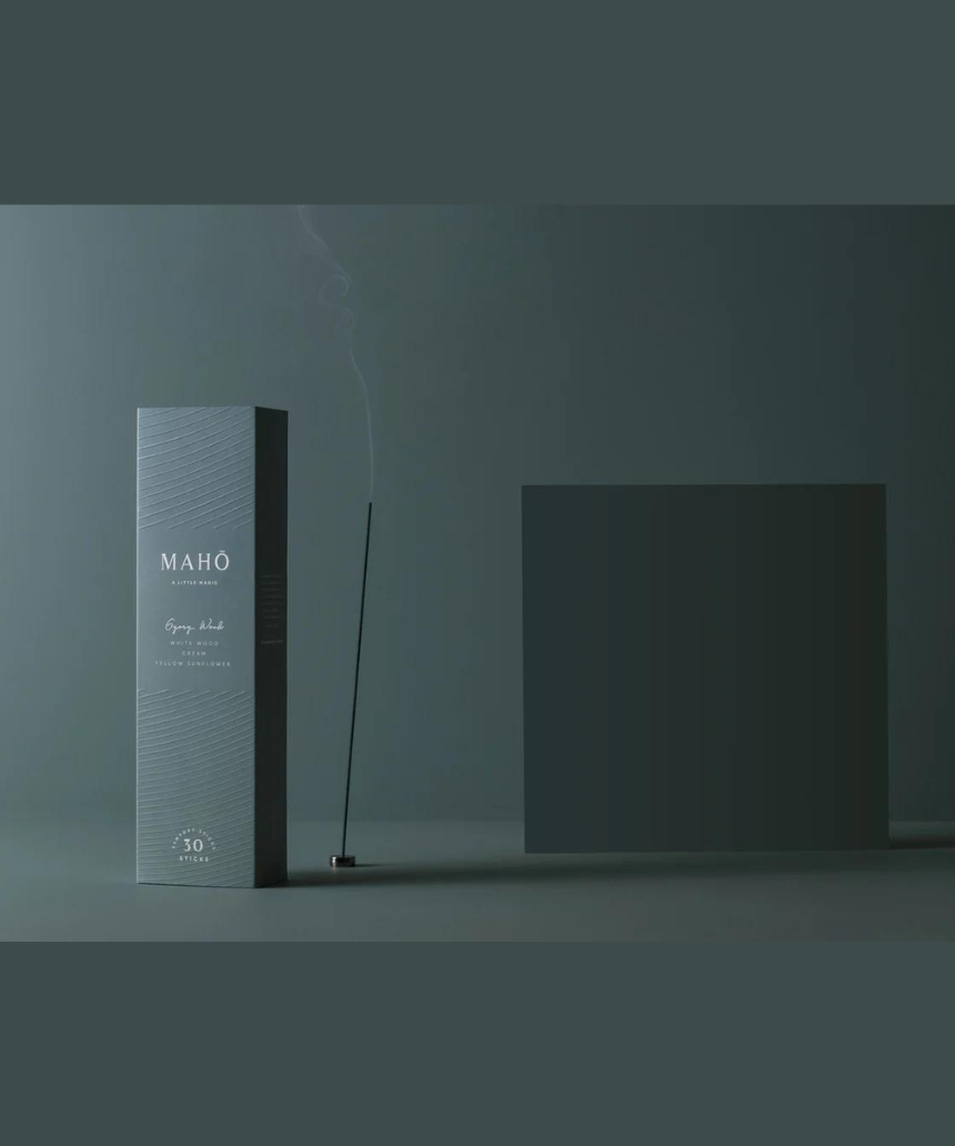 Maho Gypsy Wood Incense sticks with natural wooden packaging and burning incense, showcasing the product in a simple, elegant setting.