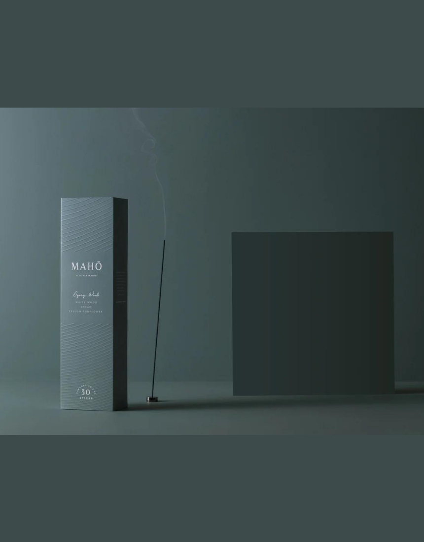Maho Gypsy Wood Incense sticks with natural wooden packaging and burning incense, showcasing the product in a simple, elegant setting.