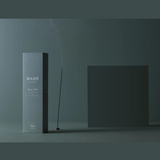 Maho Gypsy Wood Incense sticks with natural wooden packaging and burning incense, showcasing the product in a simple, elegant setting.