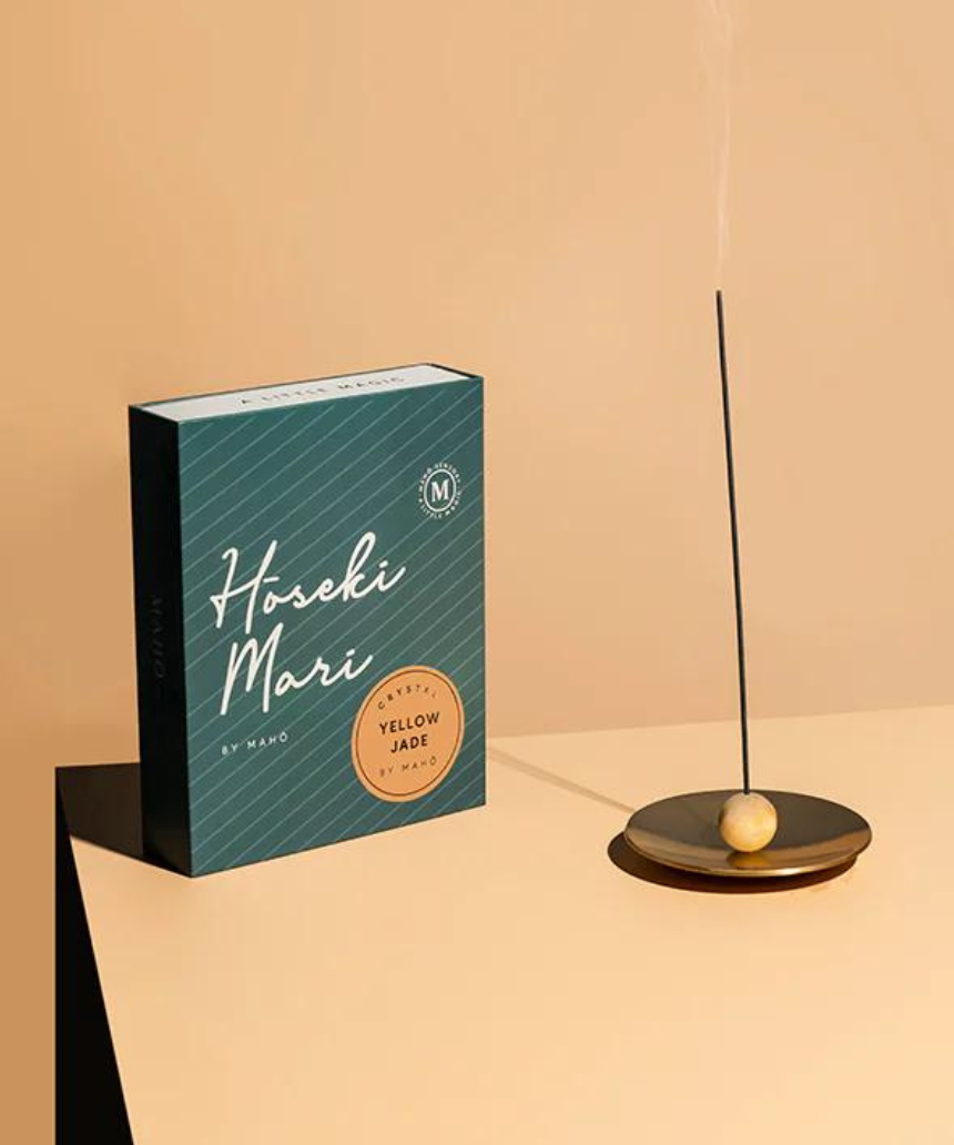 Maho Hoseki Mari yellow jade incense burner holder with intricate carved design, showcasing glossy yellow jade surface.