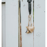 Matr Boomie Alaya Heart Wind Chime with metal and wood elements hanging from a string, designed to produce soothing sounds.