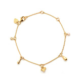 Linda Tahija Memento charm bracelet with 18k gold vermeil, featuring various charms on a delicate bracelet chain.