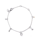 Linda Tahija Memento Charm Bracelet in sterling silver with intricate charm designs, showcasing elegant jewelry craftsmanship.