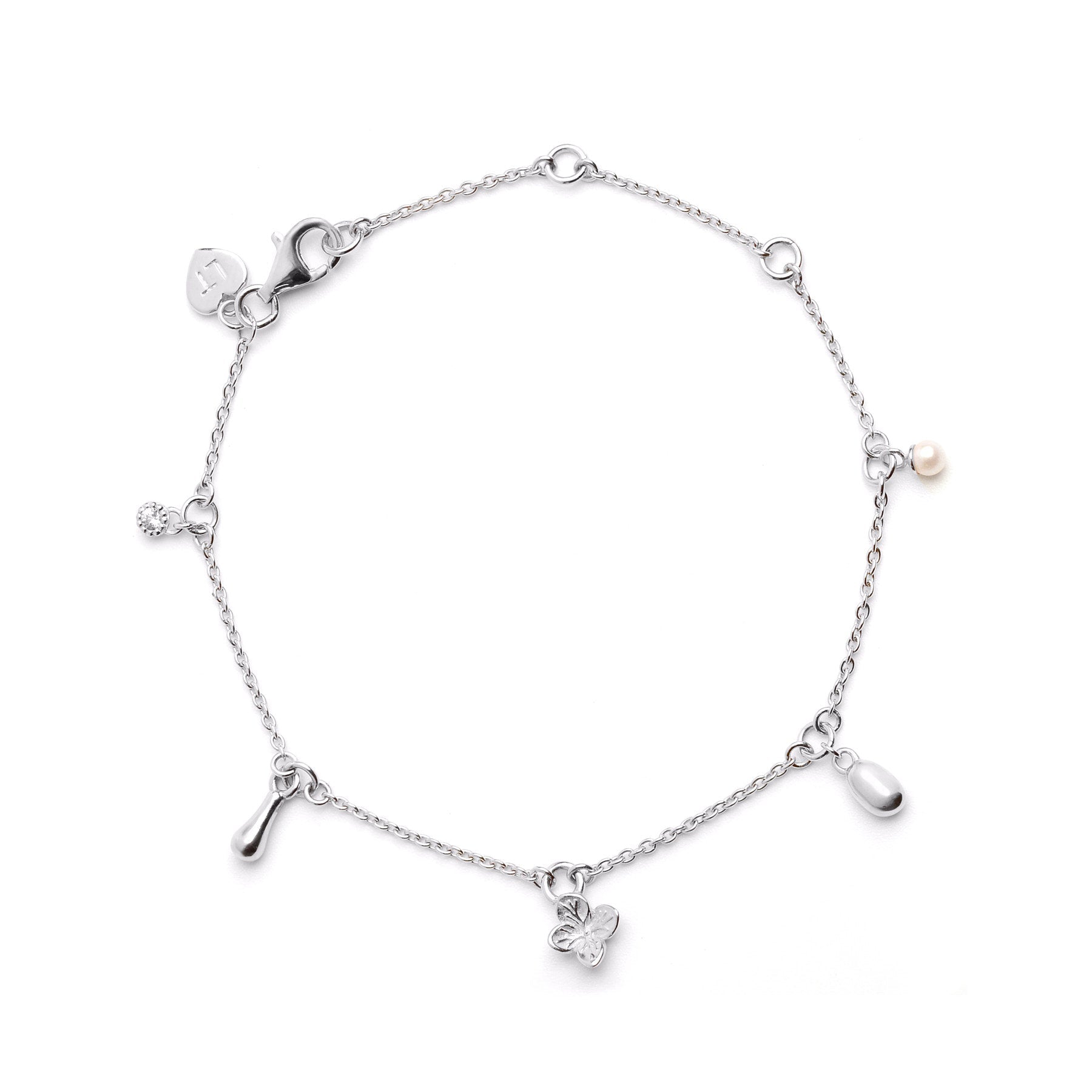 Linda Tahija Memento Charm Bracelet in sterling silver with intricate charm designs, showcasing elegant jewelry craftsmanship.