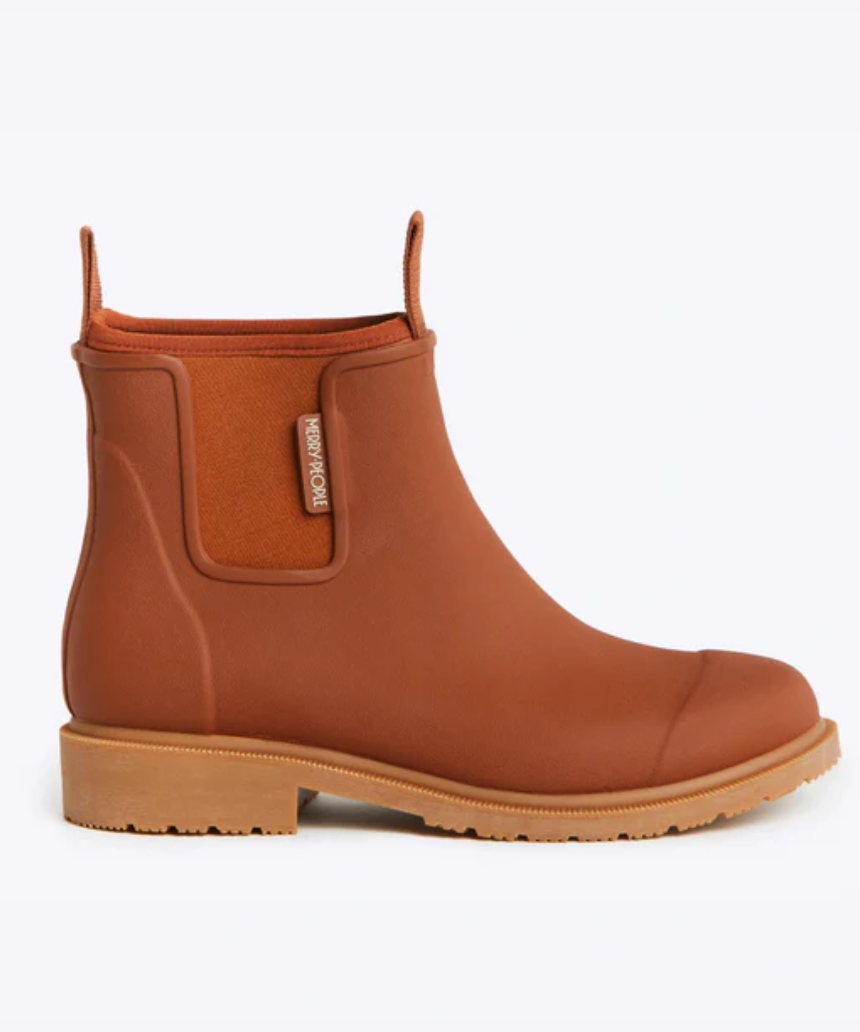 Rust-colored Merry People Bobbi Gumboot shoes with black soles and rounded toe, stylish waterproof footwear for women.