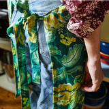 Sage x Clare Margot Linen Apron with adjustable neck strap and front pockets, featuring a stylish floral pattern.