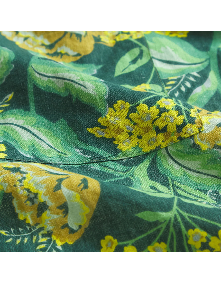 Sage x Clare Margot linen apron with a floral pattern, tied waist, and adjustable neck strap, perfect for cooking or baking.