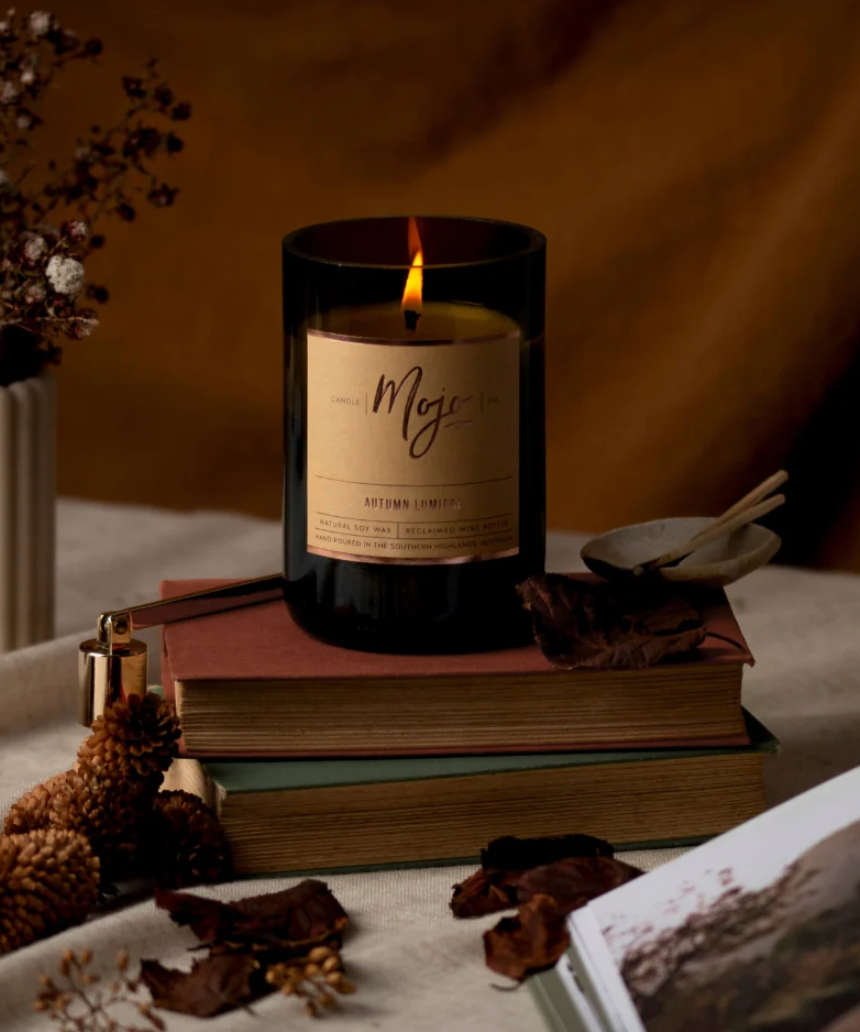 Mojo Candle Co. Autumn Lumiere limited edition candle with warm, autumn-inspired wax and decorative label.