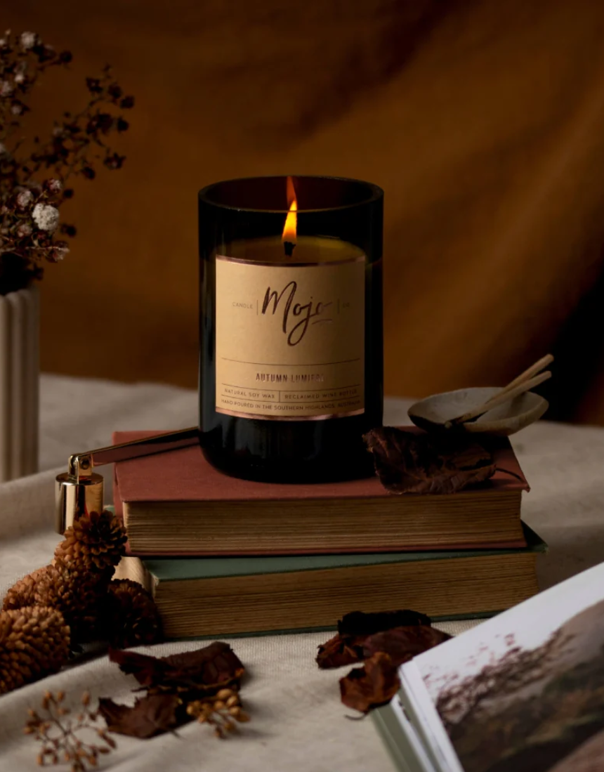 Mojo Candle Co. Autumn Lumiere limited edition candle with warm, autumn-inspired wax and decorative label.
