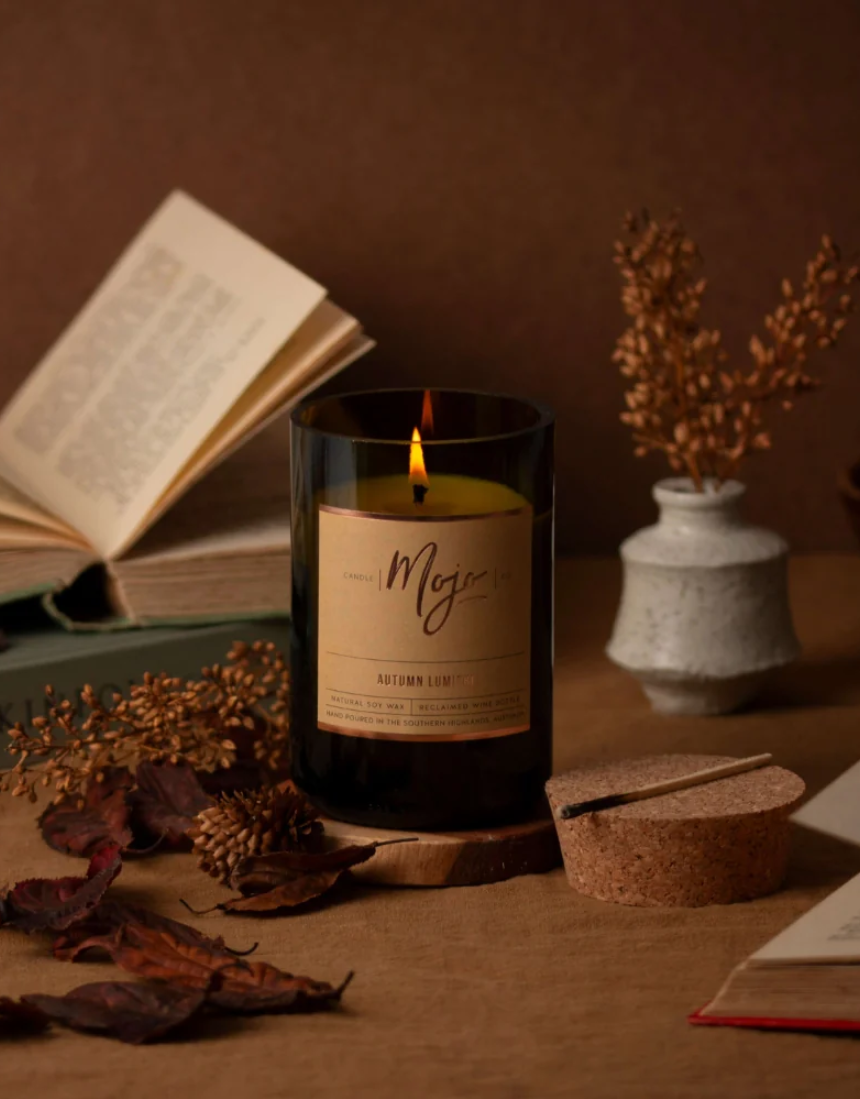 Mojo Candle Co. Autumn Lumiere limited edition candle with warm, seasonal autumn scent and decorative label.