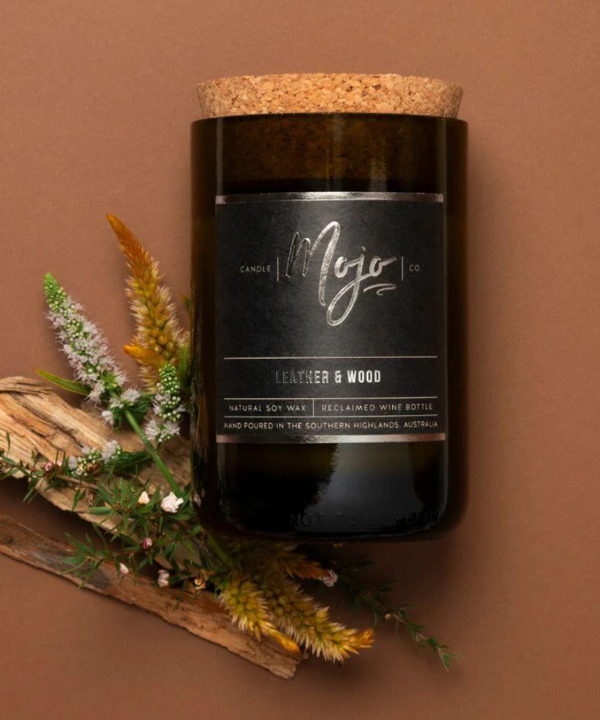 Leather and wood scented candle by Mojo Candle Co. from the Black Label collection, featuring a sleek black container.