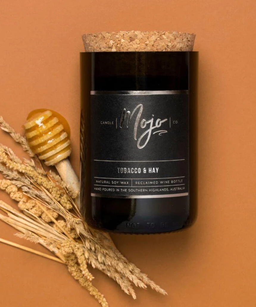 Mojo Candle Co. Tobacco & Hay Black Label candle with black label and rustic wax finish.