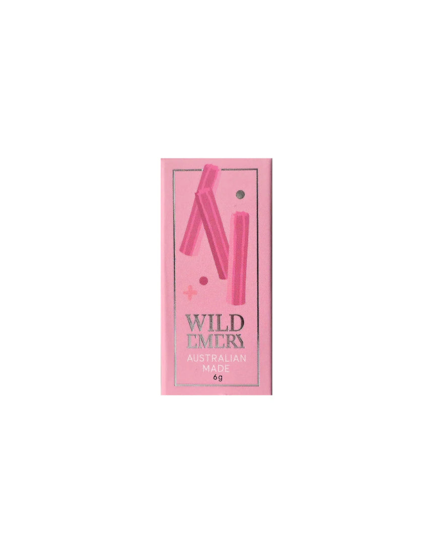 Wild Emery Musk Sticks Mini Lip Balm in a sleek lipstick tube with a smooth, natural finish.