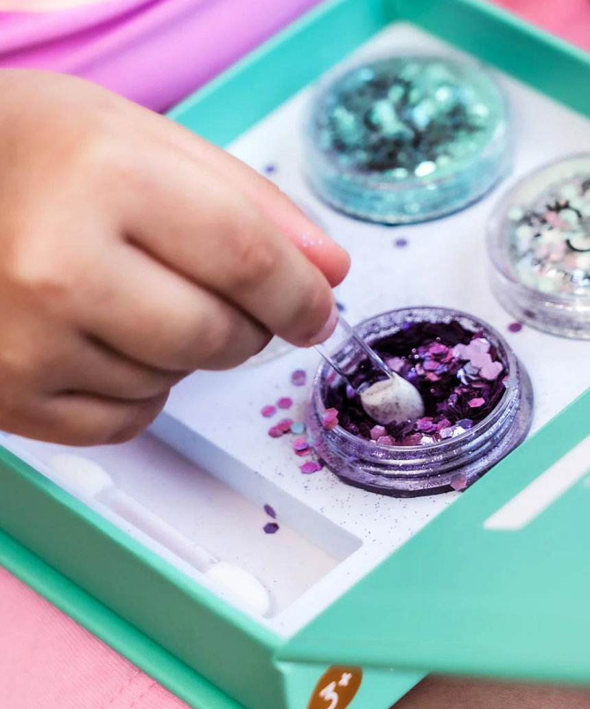 Kids Oh Flossy Under The Sea Glitter Set featuring colorful, glittery accessories for children styled with marine-themed designs.