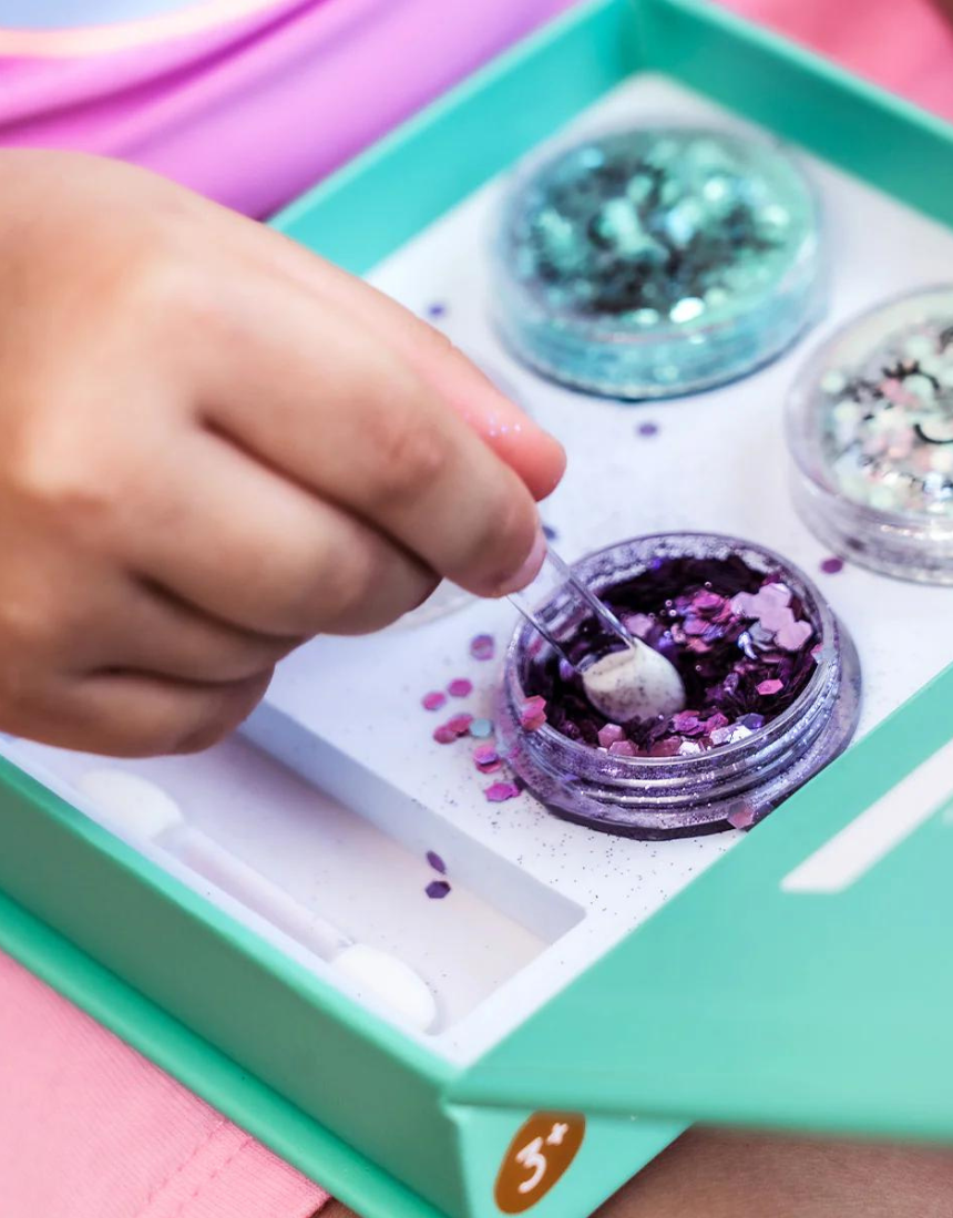 Kids Oh Flossy Under The Sea Glitter Set featuring colorful, glittery accessories for children styled with marine-themed designs.