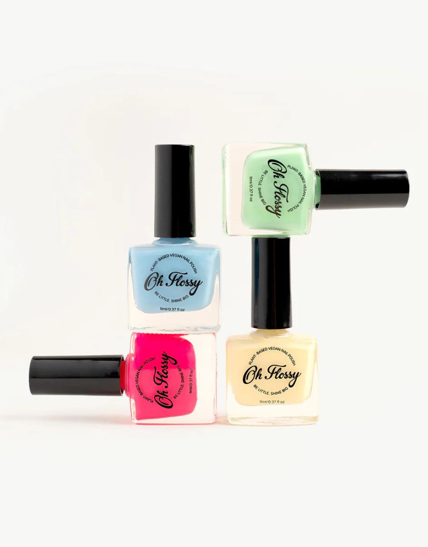 Kids nail polish in cream violet by Oh Flossy, showing a small bottle with colorful label and vibrant violet polish inside.