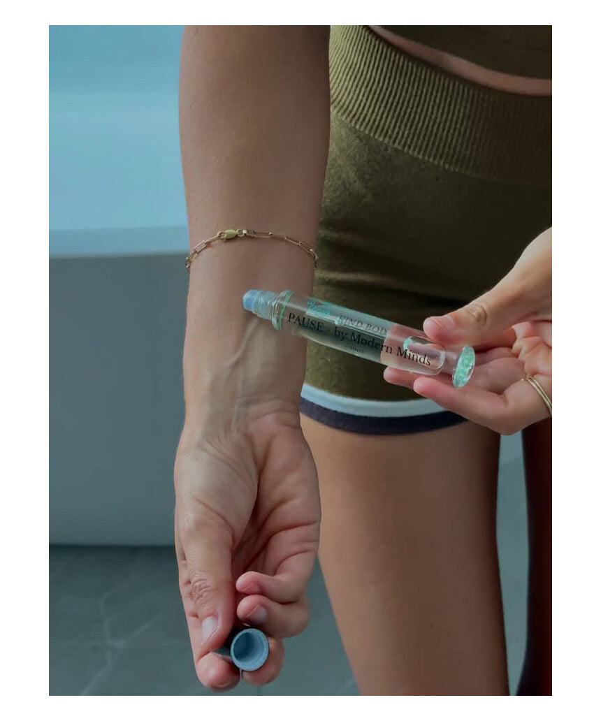 Kind Bod Pause x Modern Minds Essential Oil Roller, featuring a sleek glass bottle with a rollerball applicator and calming essential oil blend.