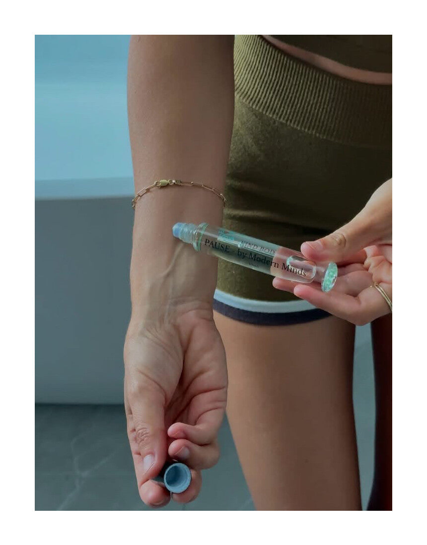 Kind Bod Pause x Modern Minds Essential Oil Roller, featuring a sleek glass bottle with a rollerball applicator and calming essential oil blend.