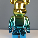 Roshi Chrome Bear sculpture with gold and blue accents, detailed metallic finish on a sleek modern design.