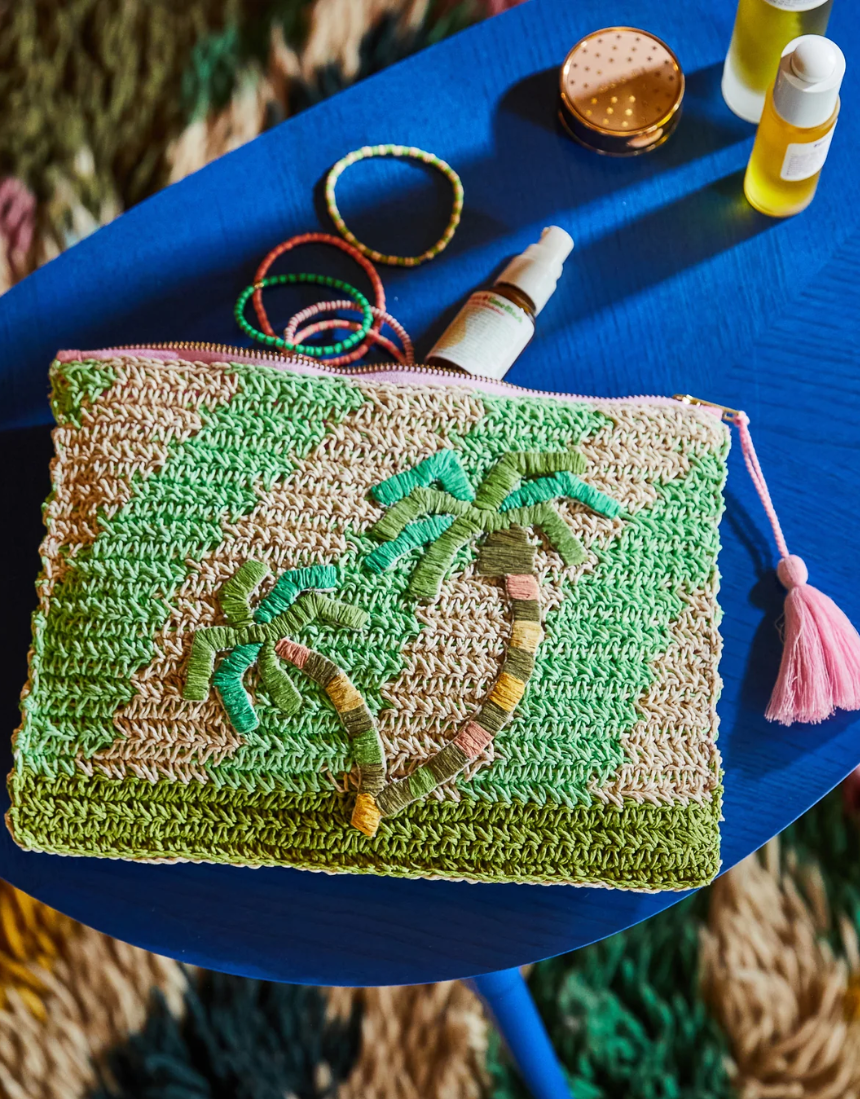 Sage x Clare San Carlos Rafia Clutch featuring woven rafia material and a sleek compact design.