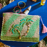 Sage x Clare San Carlos Rafia Clutch featuring woven rafia material and a sleek compact design.