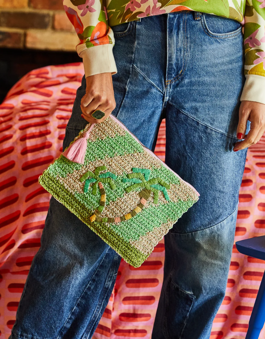 Sage x Clare San Carlos Rafia Clutch with woven design and zipper closure, featuring a stylish and textured accessory.