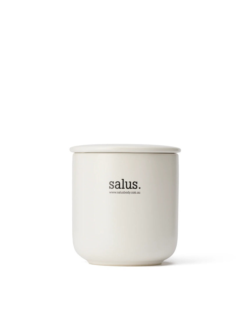 Salus Cedarwood and Geranium soy candle with a simple glass jar, showcasing natural wax and a calming, aromatic scent.
