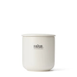 Salus Lemongrass Soy Candle with a glass jar, natural wick, and fresh lemongrass scent, burns for 55-65 hours.
