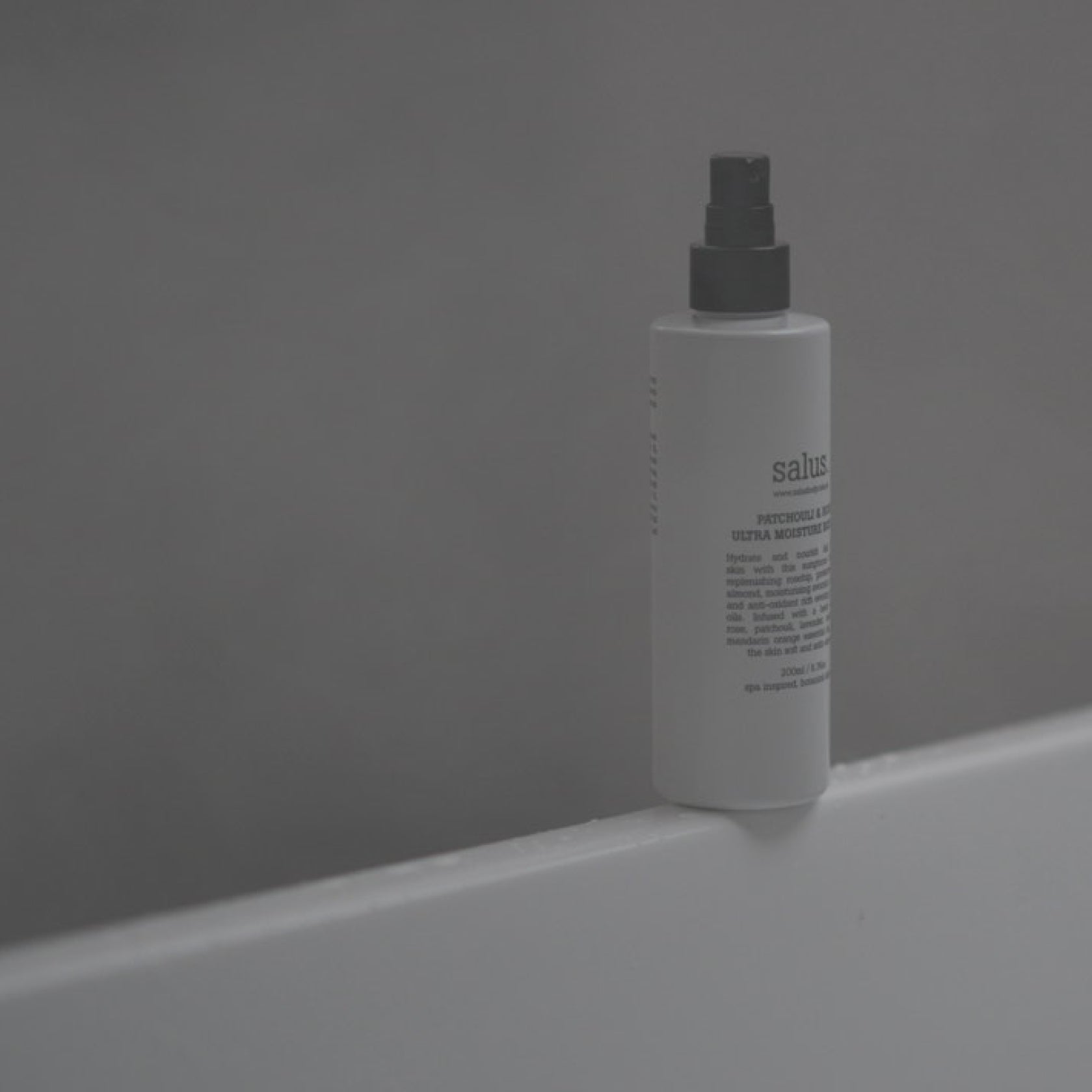 Salus Patchouli & Rose Ultra Moisture Body Oil bottle, 200ml, featuring a sleek design and transparent packaging with a floral label.