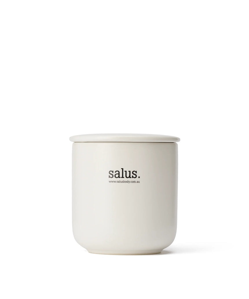 Salus Rose Geranium Soy Candle with 55-65 hour burn, featuring a glass jar and floral label, ideal for relaxing home ambiance.
