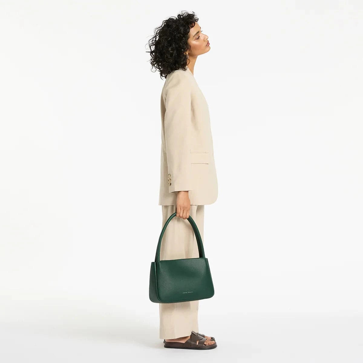 Status Anxiety Light Of Day green handbag, stylish leather purse with adjustable strap, casual everyday accessory.