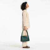 Status Anxiety Light Of Day green handbag, stylish leather purse with adjustable strap, casual everyday accessory.