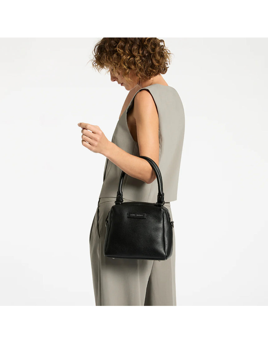 Black Status Anxiety Mini Mountains bag with compact design and adjustable strap, suitable for casual outings and everyday use.