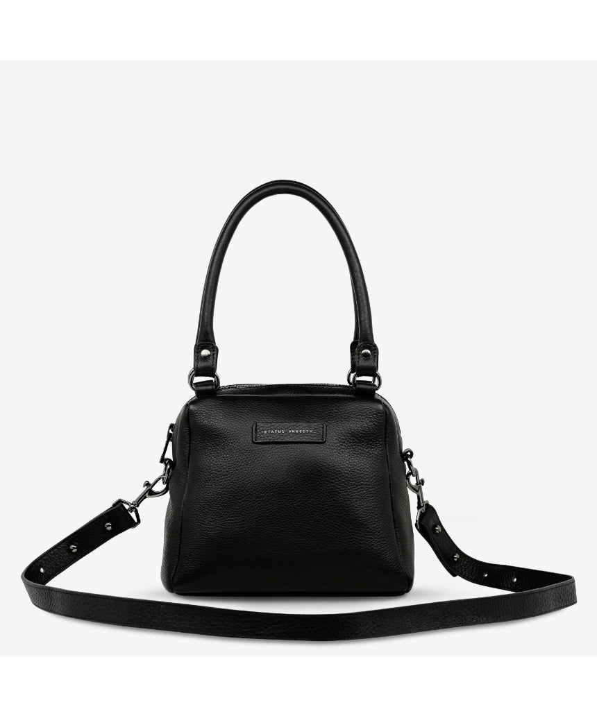 Black Status Anxiety Mini Mountains Bag with front zipper pocket and adjustable strap, stylish compact bag for everyday use.