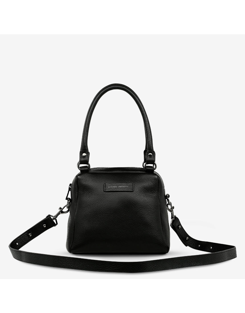 Black Status Anxiety Mini Mountains Bag with front zipper pocket and adjustable strap, stylish compact bag for everyday use.