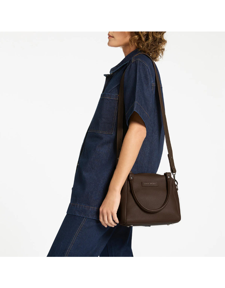 Status Anxiety Mini Mountains Bag in cocoa color, stylish small bag with adjustable strap, ideal for casual outings.