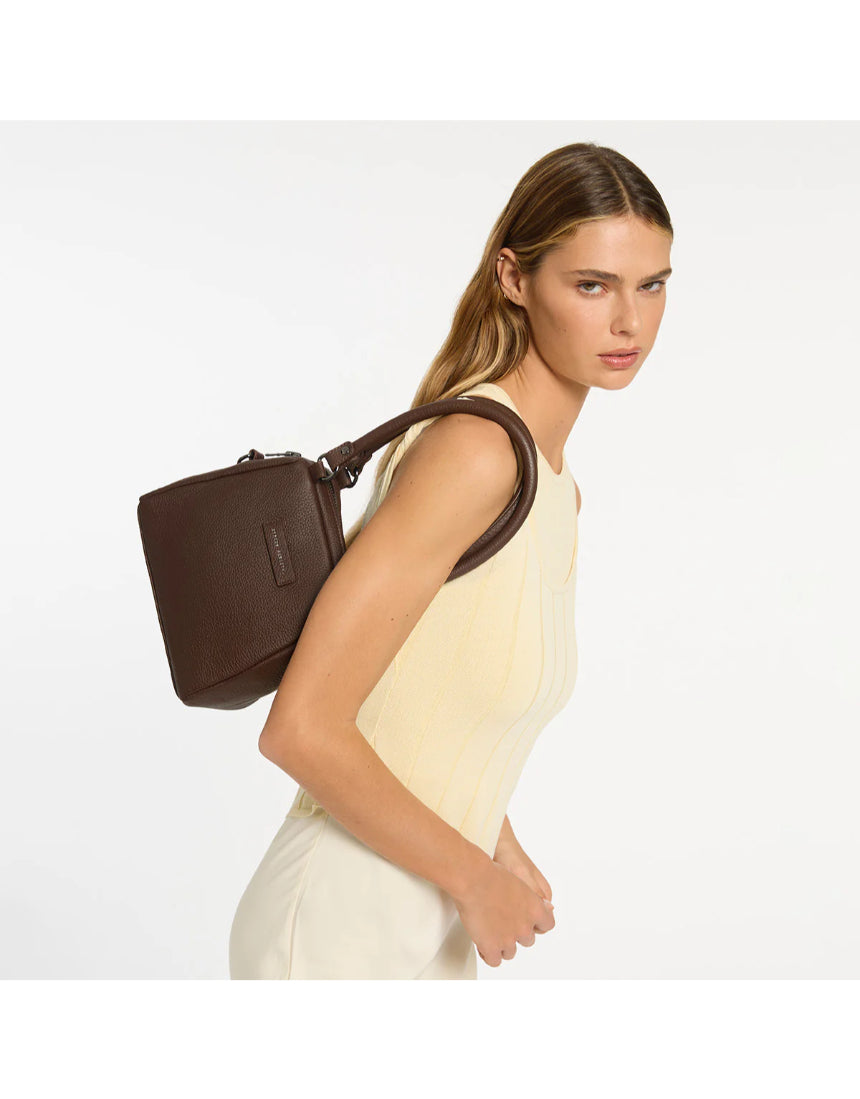 Status Anxiety Mini Mountains Bag in cocoa color, featuring a compact design with adjustable strap and stylish mountain pattern.