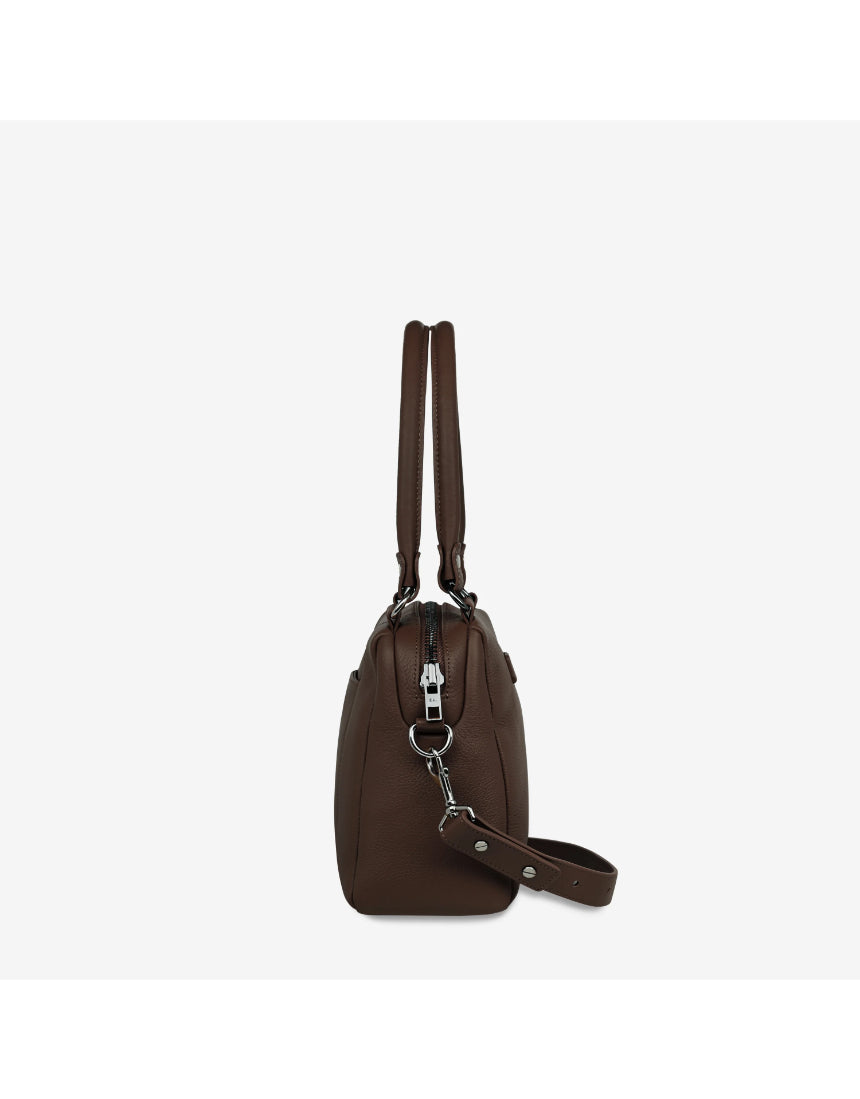 Status Anxiety Mini Mountains Bag in cocoa color, showing side view with mountain-inspired textured design and compact shape.