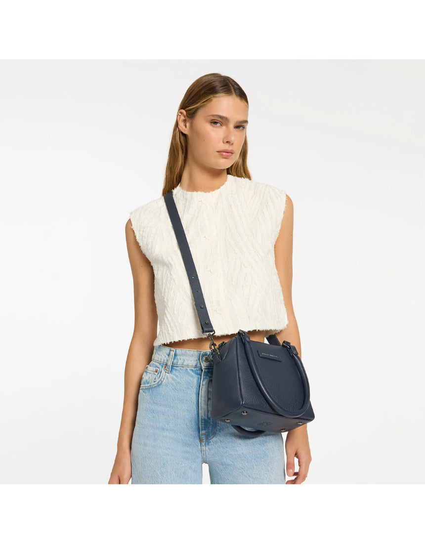 Mini Mountains bag by Status Anxiety in midnight blue, featuring a compact design and stylish zipper closure.