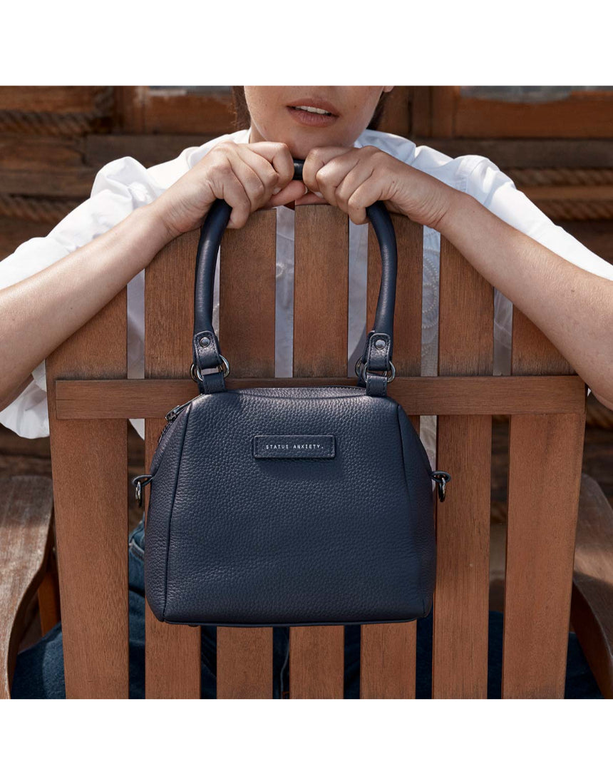 Status Anxiety Mini Mountains bag in midnight blue, stylish and compact bags with mountain-inspired design and adjustable strap.