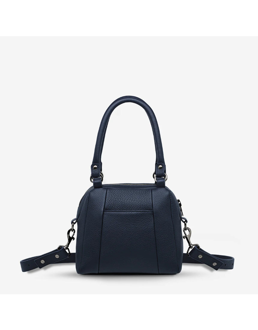 Midnight blue Status Anxiety Mini Mountains bag showing front view with adjustable strap and minimalist mountain design.